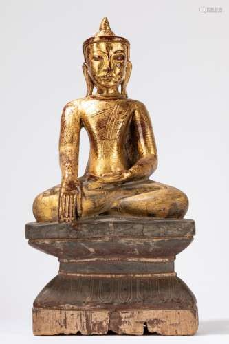 A gilt and lacquered wood seated Buddha. Burma, early 20th c...