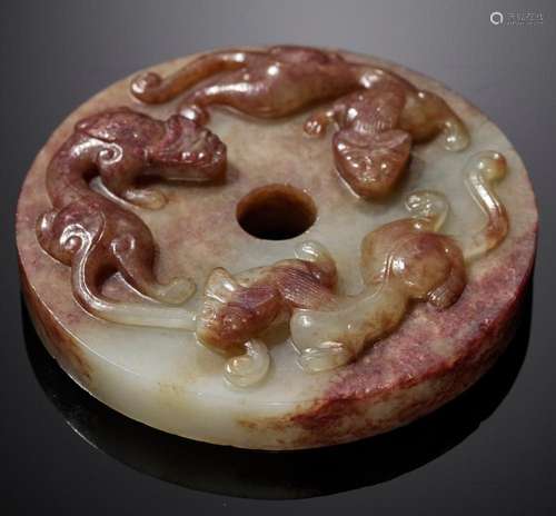 AN ARCHAISTIC CELADON AND RUSSET JADE ‘CHILONG’ DISC, BI, MI...