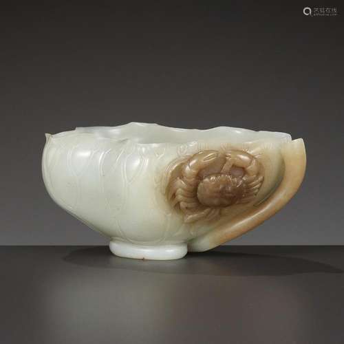 A WHITE AND BROWN JADE ‘LOTUS, CRAB AND MILLET’ BRUSH WASHER...