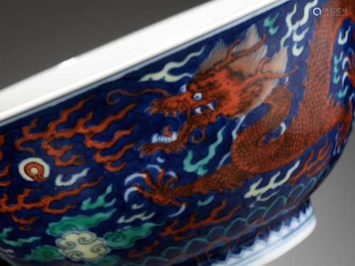 A RARE BLUE-GROUND POLYCHROME-DECORATED ‘DRAGON’ BOWL, QIANL...