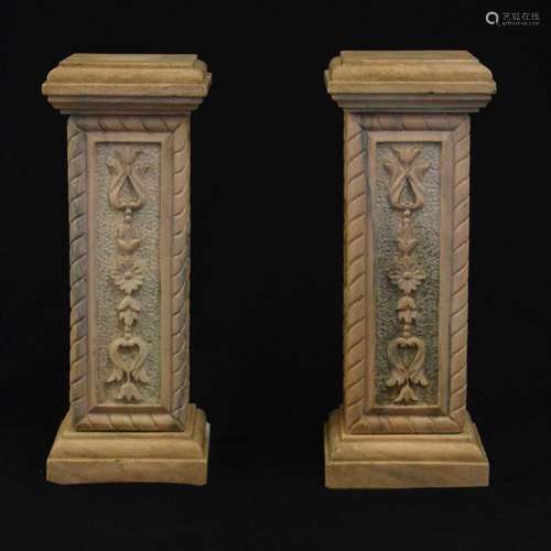 Pair of pink carved pedestals