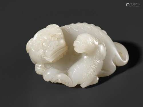 A WHITE JADE WEIGHT OF A BUDDHIST LION WITH CUB, 17TH CENTUR...