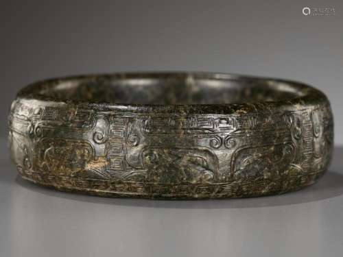 AN ARCHAISTIC SPINACH-GREEN JADE ‘TAOTIE’ BANGLE, LATE MING ...