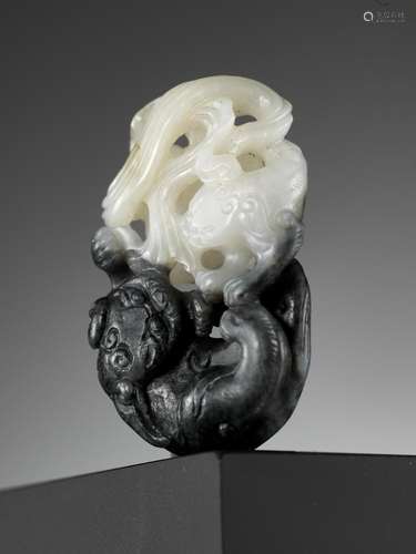 A BLACK AND WHITE JADE ‘BUDDHIST LIONS’ PENDANT, 18TH CENTUR...