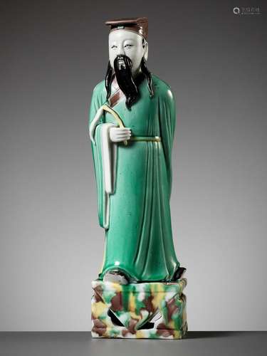 A GREEN, YELLOW AND AUBERGINE-GLAZED BISCUIT FIGURE OF A DAO...