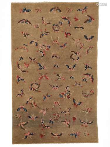 A BAOTOU ‘HUNDRED BUTTERFLIES’ WOOL RUG, LATE QING DYNASTY T...