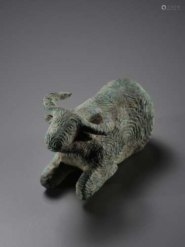 A RARE BRONZE FIGURE OF A RECUMBENT BUFFALO, DONG SON CULTUR...