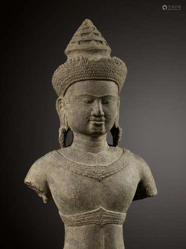 A SANDSTONE FIGURE OF A MALE DEITY, ANGKOR WAT PERIOD, BAPHU...