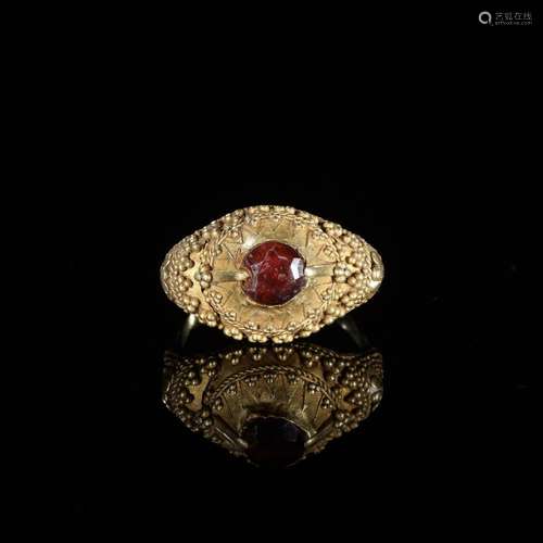 A GARNET-SET GOLD ‘FLORAL’ PRIEST’S RING