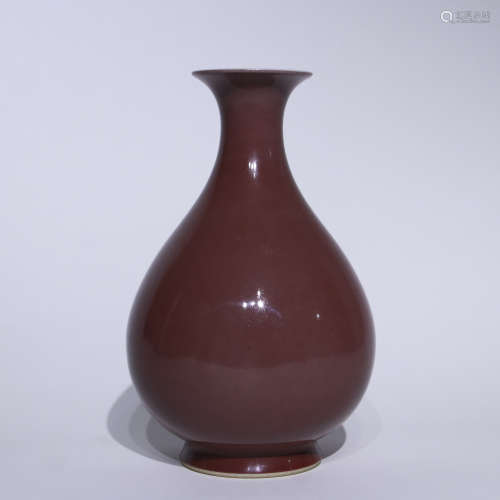 A red glazed pear-shaped vase