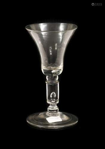 A Wine Glass, circa 1730, the bell-shaped bowl with air tear...