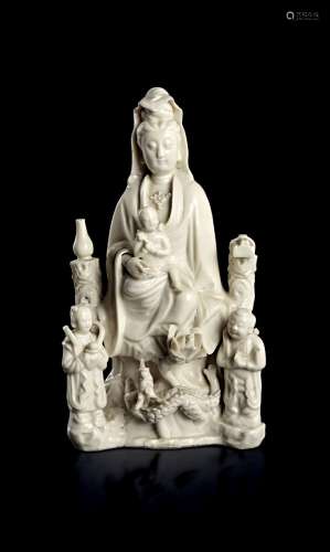A CHINESE DEHUA PORCELAIN FIGURE OF GUANYIN AS THE 'BRINGER ...