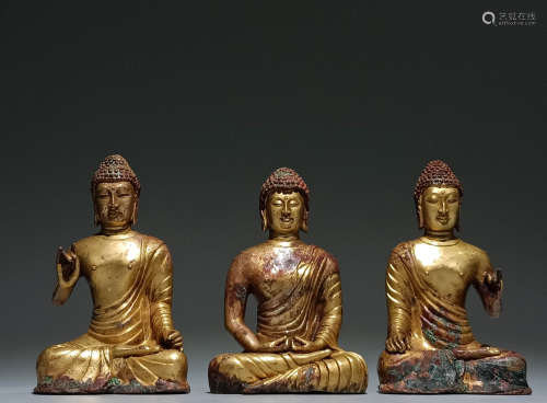 In ancient China, a group of gilded seated statues of Sakyam...