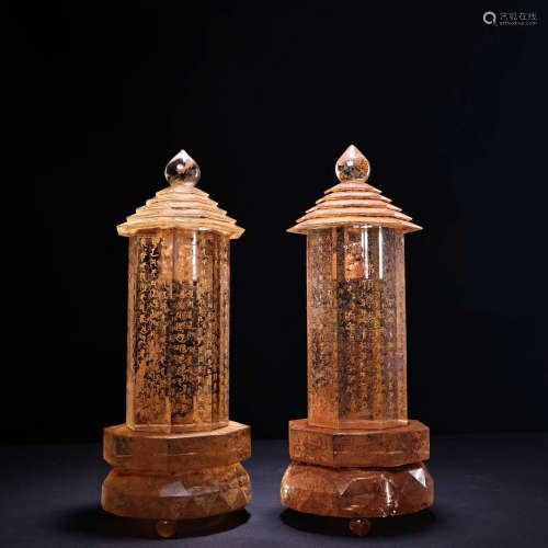 A pair of crystal carved scriptures with gold relics and pag...