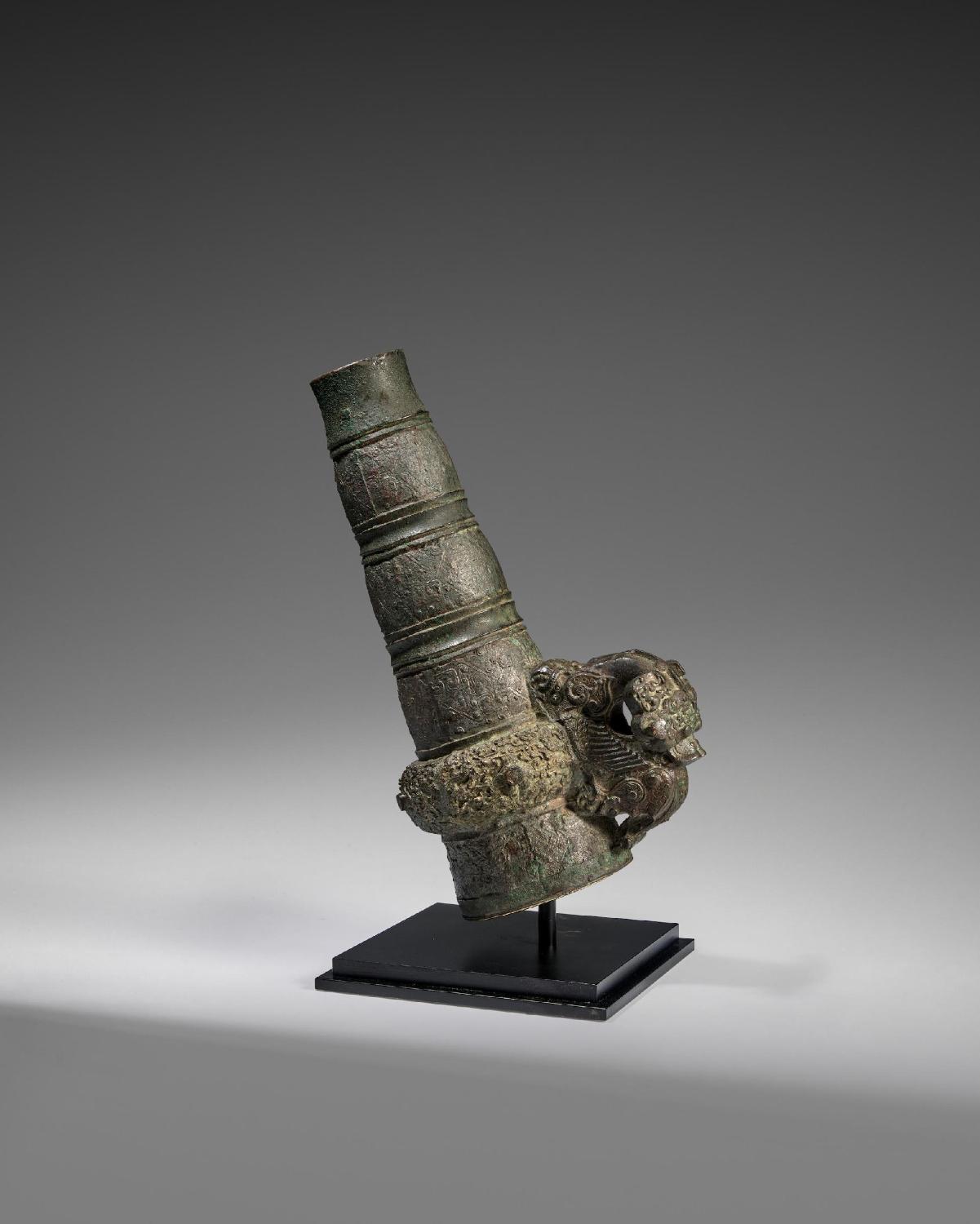 A RARE ARCHAIC BRONZE HANDLE FOR A BELL, YONG Eastern Zhou d