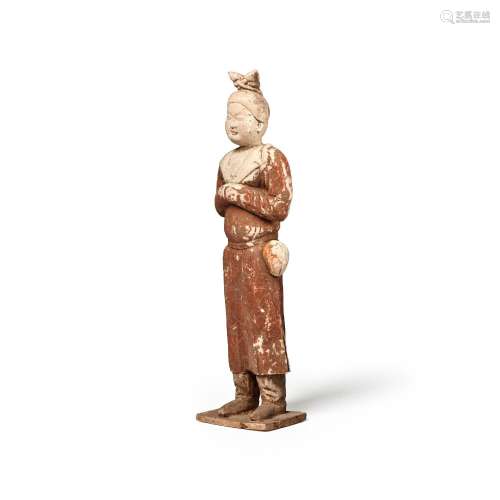 AN UNUSUAL PAINTED POTTERY FIGURE OF AN ATTENDANT  Tang dyna...