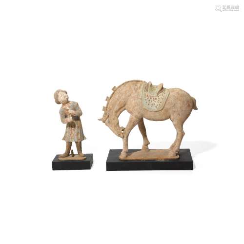 A PAINTED RED POTTERY GROOM AND A HORSE Tang dynasty