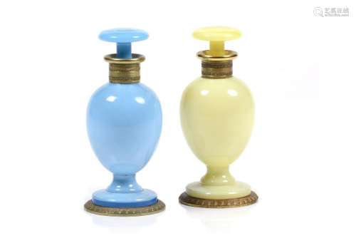 Two perfume bottles and stoppers
