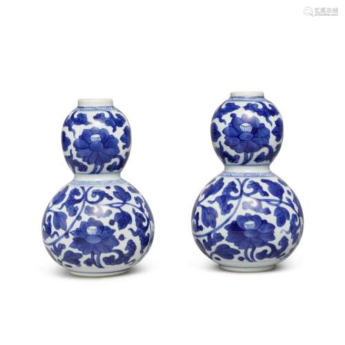 A pair of blue and white 'scrolling peony' double-gourd vase...