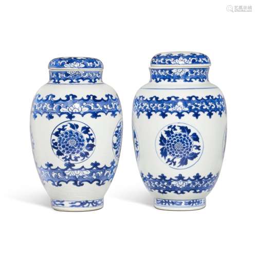 A pair of blue and white 'chrysanthemum' ovoid jars and cove...