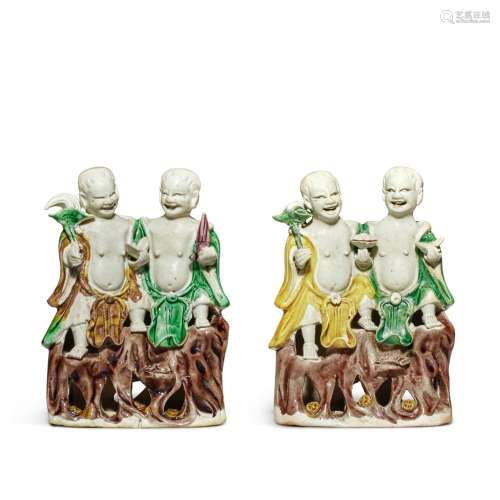 A pair of famille-verte biscuit figures of 'Hehe Erxian', Qi...