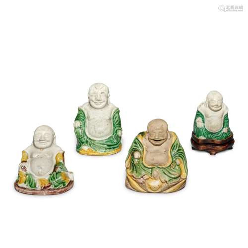 A group of four famille-verte biscuit figures of Budai, Qing...