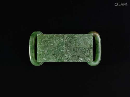 A spinach-green jade 'dragon' belt buckle, Qing dynasty, 19t...