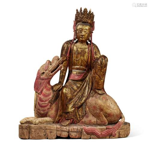 A polychrome-painted and gilt-decorated wood seated figure o...