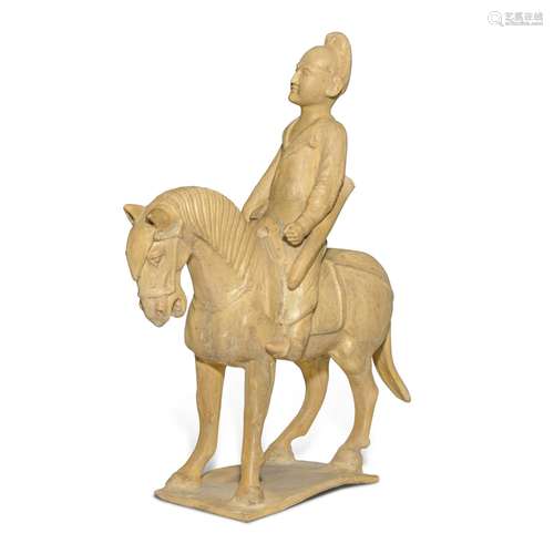 A straw-glazed pottery figure of a horse and equestrian, Tan...