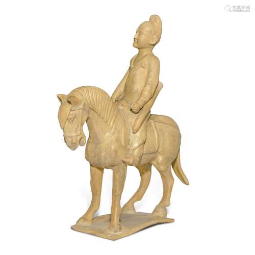 A straw-glazed pottery figure of a horse and equestrian, Tan...