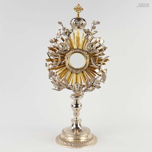 A sunburst monstrance, silver, decorated with angels, wheat ...