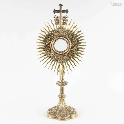 A sunburst monstrance, gilt silver decorated with cabochons,...