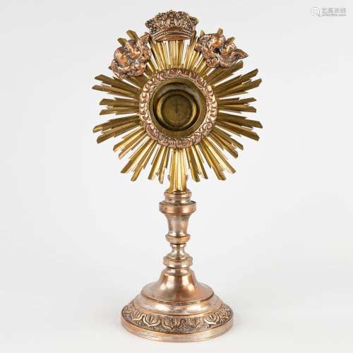 A small sunburst monstrance with a relic of the true cross. ...