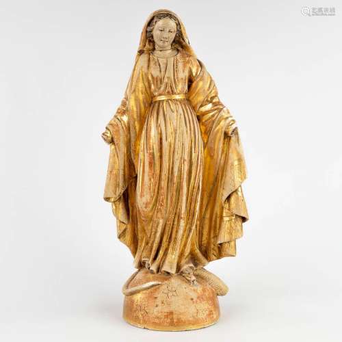 An antique gilt wood figurine of Madonna standing on the cre...