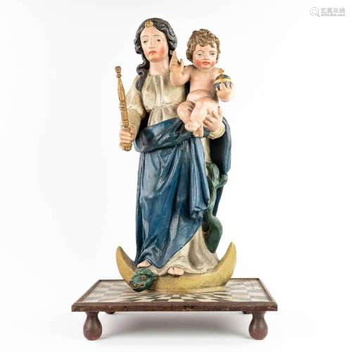 A patinated wood statue of Madonna with a child, Serpent and...