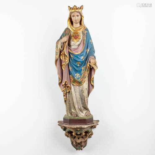 A figurine of Madonna, standing on a plaster console. (W:20 ...