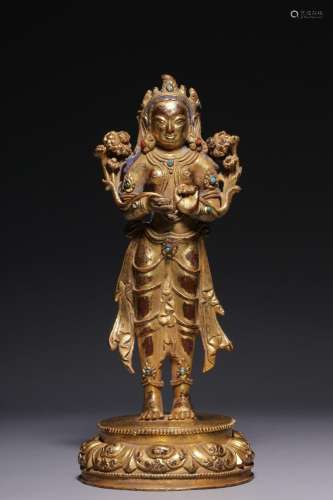 A gilt-bronze statue of Avalokitesvara holding a lotus