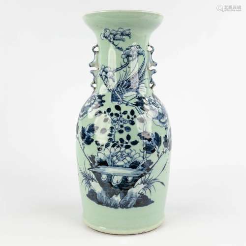 A Chinese celadon vase with blue-white decor of flora. 19th/...