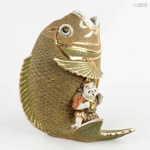 A figurine seaed on a koi, Satsuma stoneware. Meji period. (...