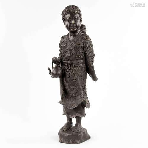 A Japanese Okimono of a mother with child, patinated bronze....