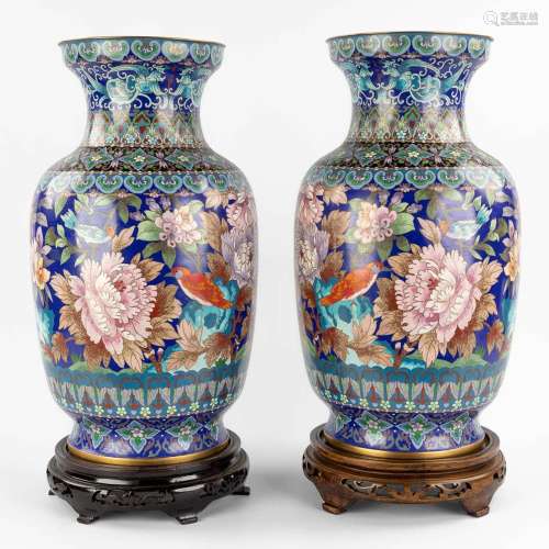 A pair of large cloisonné vases decorated with fauna and flo...