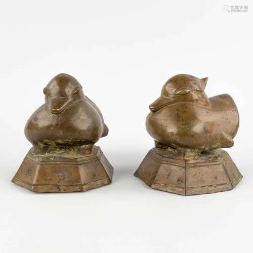 A pair of Oriental weights, decorated wtih ducks. Bronze. (D...