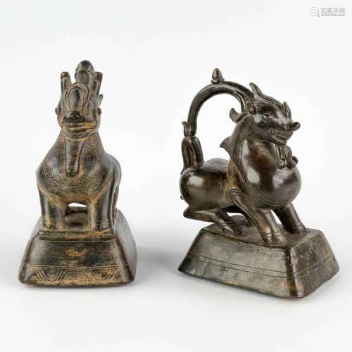 A pair of Oriental weights, decorated with mythological figu...