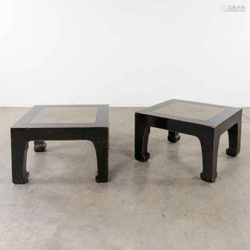A pair of Chinese coffee tables, black lacquered with a ston...