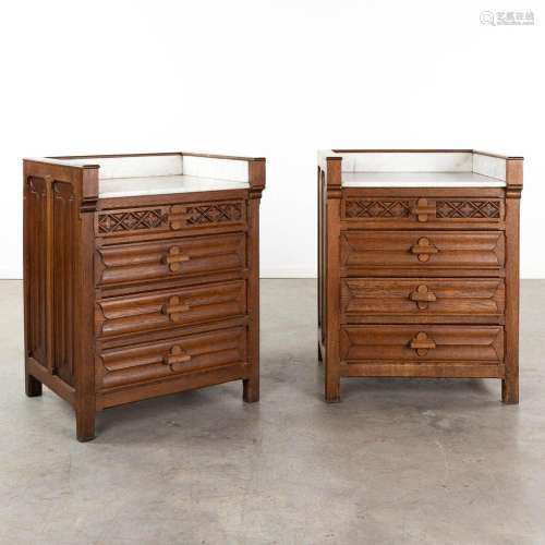 A pair of wood-sculptured cabinets in a gothic revival style...