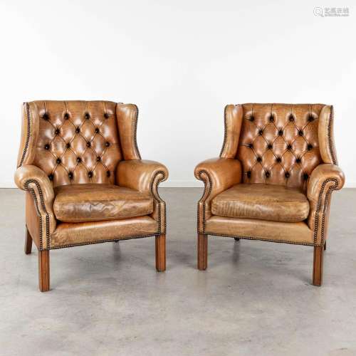 A pair of leather armchairs in Chesterfield style. (D:82 x W...