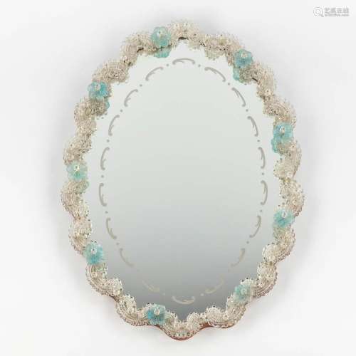 A small Venetian glass wall-mounted mirror, decorated with b...