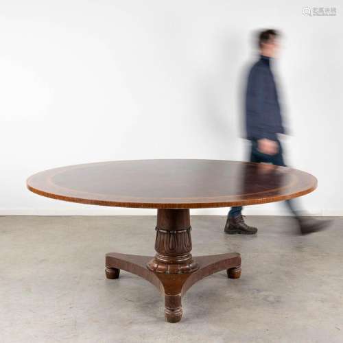 An exceptionally large round table with a marquetry veneer t...