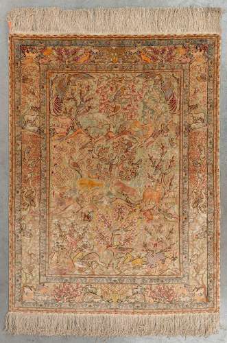 An Oriental hand-made carpet, decorated with fauna and flora...