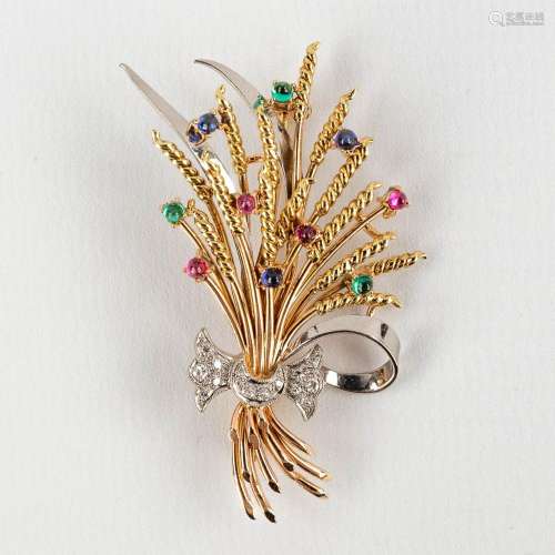 A brooch in the shape of a stack of wheat, with glass caboch...